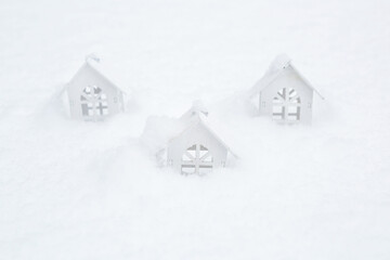 White wooden houses in the snow. The concept of comfort, rural life, mortgage, rent, booking