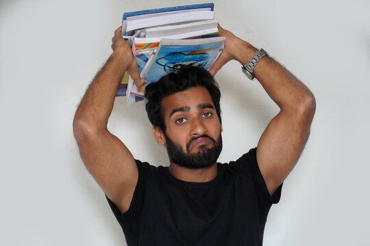 A Young Student is not intrested in reading showing his negative expression