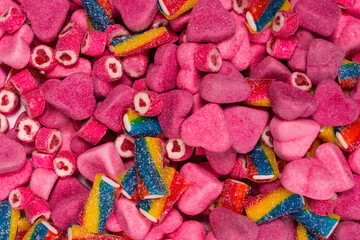 Fototapeta na wymiar Assorted tasty gummy candies. Pink jelly sweets background.