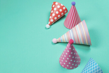 Colorful birthday caps on a blue background. Top view.