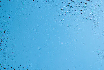 Blue backgrond with water drops. Wet glass.