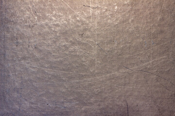 The surface of a scratched sheet of metal, with dots, potholes and scratches. Uneven texture with lines, stripes and pattern.