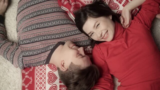 Cute couple in love enjoying xmas and lying head to head. Top view. Relationship, family, christmas, new year, holiday concet.