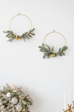 Stylish Christmas Wreaths On White Wall In Home Interior