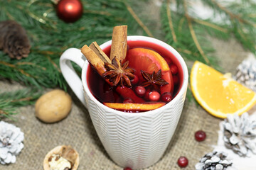 Obraz na płótnie Canvas mulled wine drink in a white mug, concept holiday Christmas anise cinnamon orange cranberry