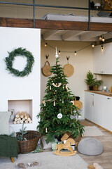 Stylish Christmas decor in a Scandinavian country house in beige tones. Fireplace and Christmas tree in the living room