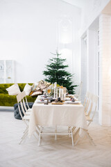A cozy festive table for celebrating Christmas or New Year in a classic style.