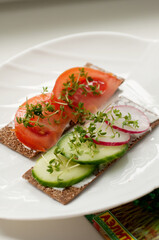 sandwiches with tomatoes, cucumbers and radishes with micro-greenery on bread rolls