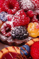 Fresh cake with raspberries in powdered sugar. Dessert in a cafe for breakfast.