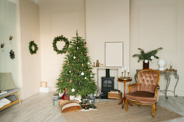 Cozy Christmas interior of the living room with a fireplace and a Christmas tree, an armchair and decor for the New Year