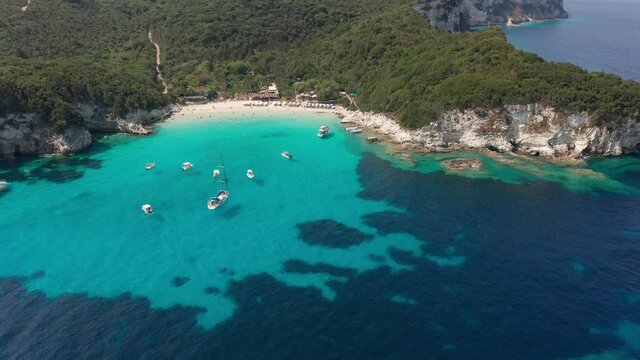 Aerial view of anchored boat on paradise turquoise sea of Vrika beach at Paxos island Greece