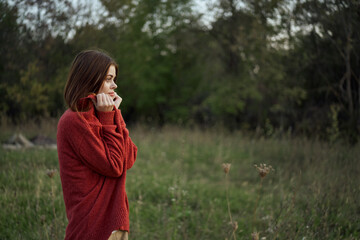 woman outdoors in a red sweater cool nature