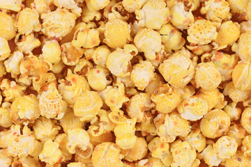 Sweet popcorn with caramelized yellow sugar and sprinkles