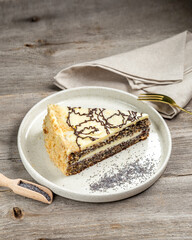 Poppy Seed Cake on the white plate on wooden table