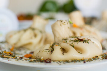 Georgian khinkali with meat on the white background with spices