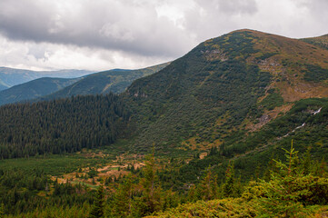 View of the Chornohora mountain with a waterfall. Carpathians in Ukraine in summer. The source of the Prut River