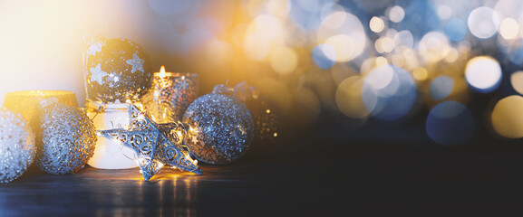 background banner for christmas and new year with christmas tree decorations candles and glowing...