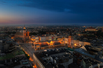 Illuminated Cracow main square at dawn. Aerial view.