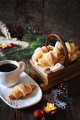 Cottage cheese croissants, cup of coffee and New Year's decoration