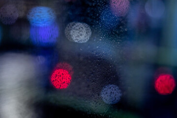 Drops on the glass with lights in the form of bokeh