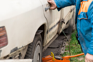 Repair of the rear door of the car. Elimination of the broken body of transport