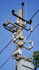 Close-up high voltage power line on a background of blue sky on a sunny day. Electro pole, pole...