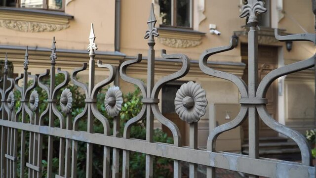 Metal fence design elements in retro vintage style. House fencing in the city. Landscape design constructions in Old Town historical architecture.