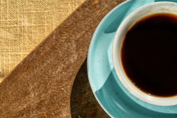 Cup of coffee on wooden desk background .