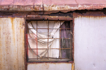 An old, rusty metal booth (house). Housing of the poor and homeless.
