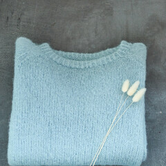 Blue knitted sweater handmade isolated gray backround