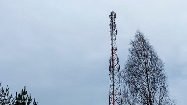 Tower with mobile operator antennas on the dramatic sky background. Tower hosted equipment cellula.