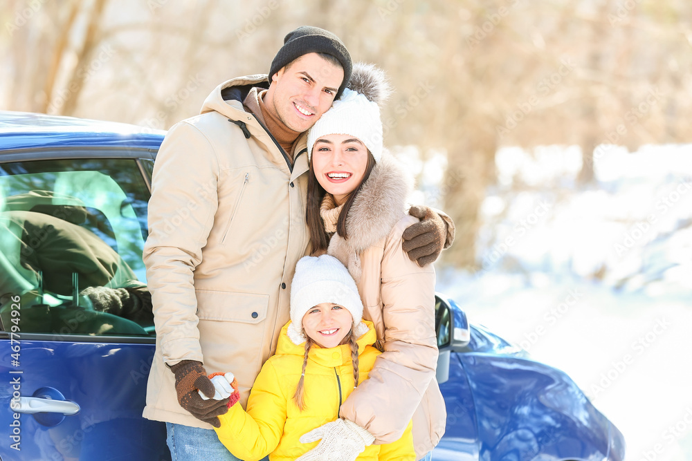 Poster Happy family near car in forest on winter day