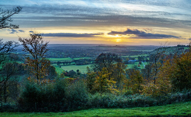 scenic Westerly view as the golden sun sets over Oare and across the Pewsey Vale valley, North Wessex Downs AONB
