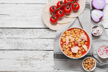 Bowl with delicious homemade pozole soup and ingredients on light wooden background