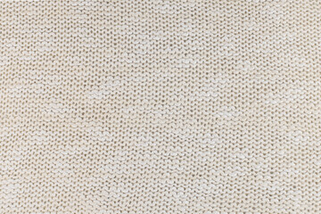 Texture of natural ivory knitted fabric close-up. the background for your winter mockup
