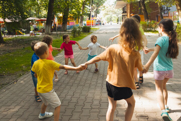 The group of little friends actively resting in the park