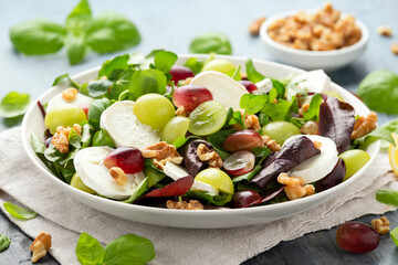 Italian salad with goat cheese, grapes and walnuts. Healthy Food