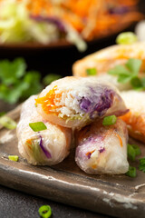 Fried Vegan spring rolls, rice paper dumplings with sweet and purple cabbage, rice noodles and carrots