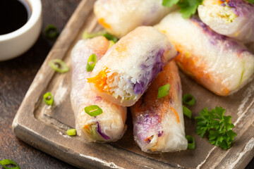 Fried Vegan spring rolls, rice paper dumplings with sweet and purple cabbage, rice noodles and carrots