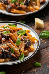 Pasta alla Norma with eggplant or aubergine, tomato, parmesan and basil. Healthy food