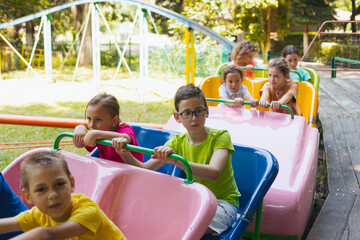 Fototapeta na wymiar The happy little children are resting in the amusement park