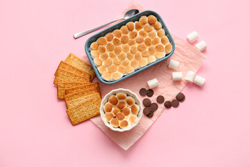 Baking dish and ramekin with tasty S'mores dip on pink background - obrazy, fototapety, plakaty