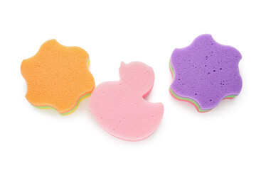 Cute star and duck shaped bath sponges on white background