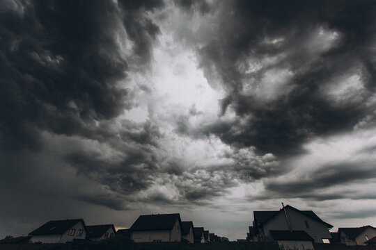 storm clouds over houses
