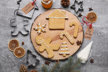 Composition with Christmas gingerbread cookies and spices on grey background