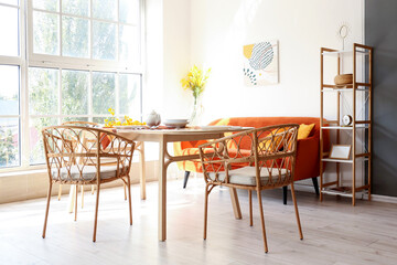 Interior of light dining room with wicker chairs