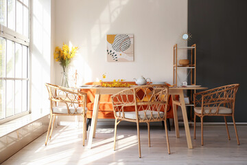 Interior of light dining room with wicker chairs