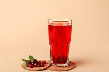 Glass with healthy cranberry juice on color background