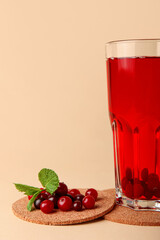 Glass with healthy cranberry juice on color background