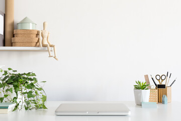 Laptop on creative desk full of school accessories. Learning workspace.	
